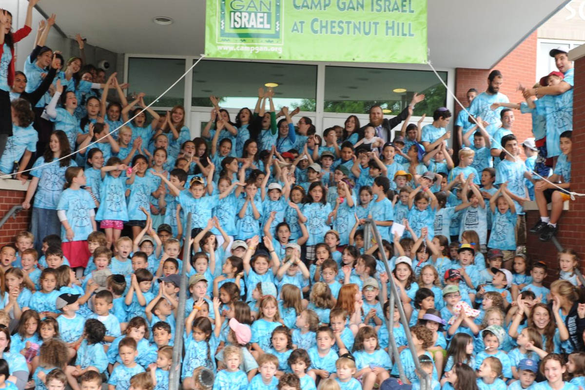 Campers at Camp Gan Israel at Chestnut Hill cheering on the front steps
